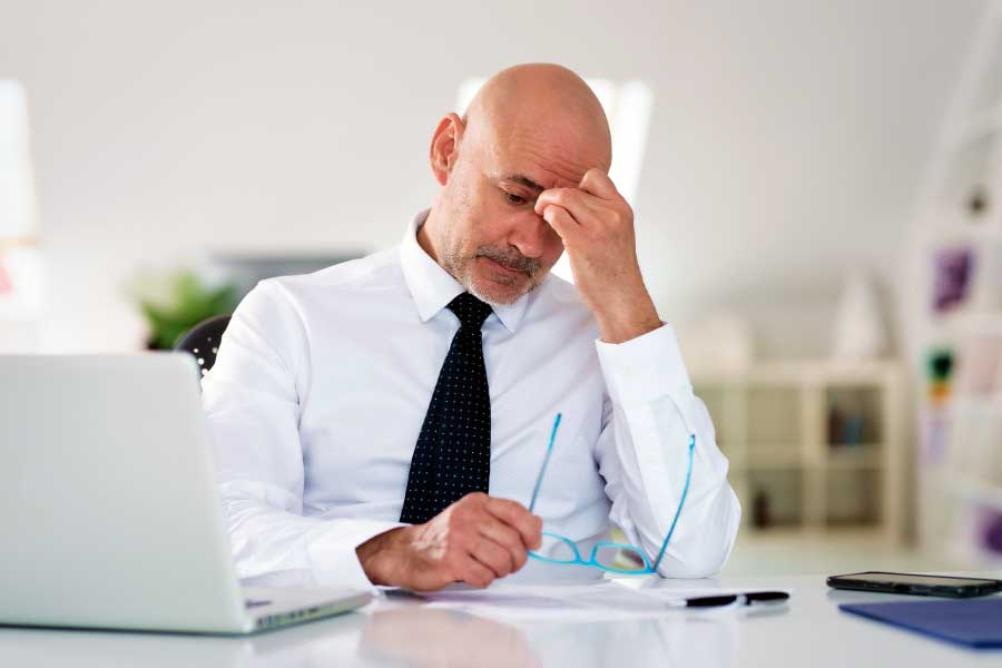 Businessman sits at his desk with a worried expression