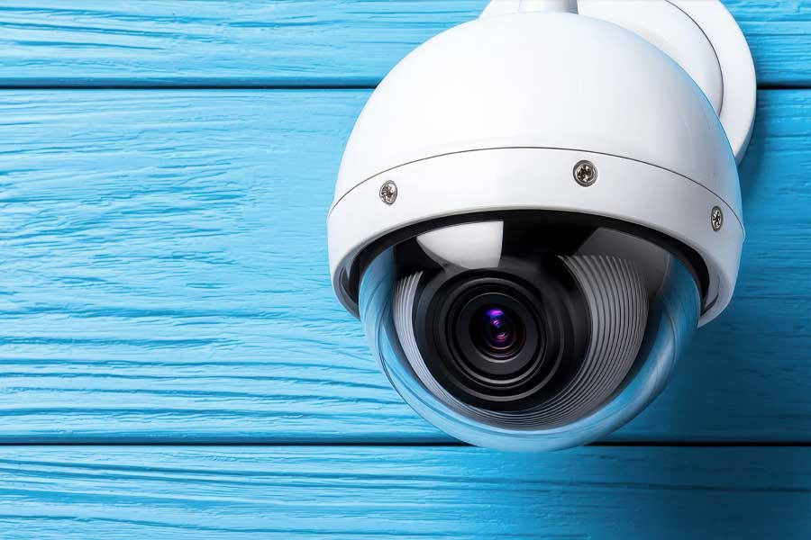 Camera mounted on wooden wall with dome security camera