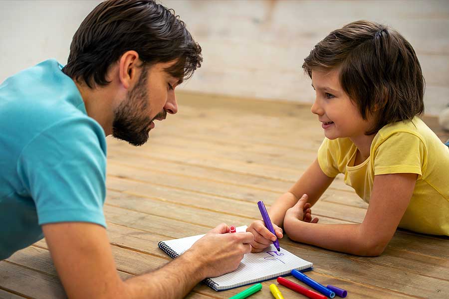 Father and son draw together and bond during supervised visitation.